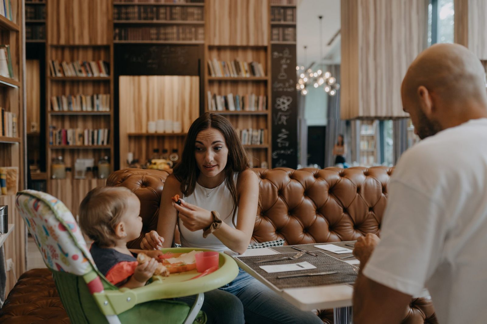 Parents and their toddler at breakfast, the child in a high chair
