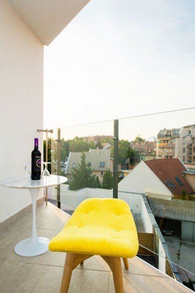 The balcony of the Executive Family Room with a table and chairs