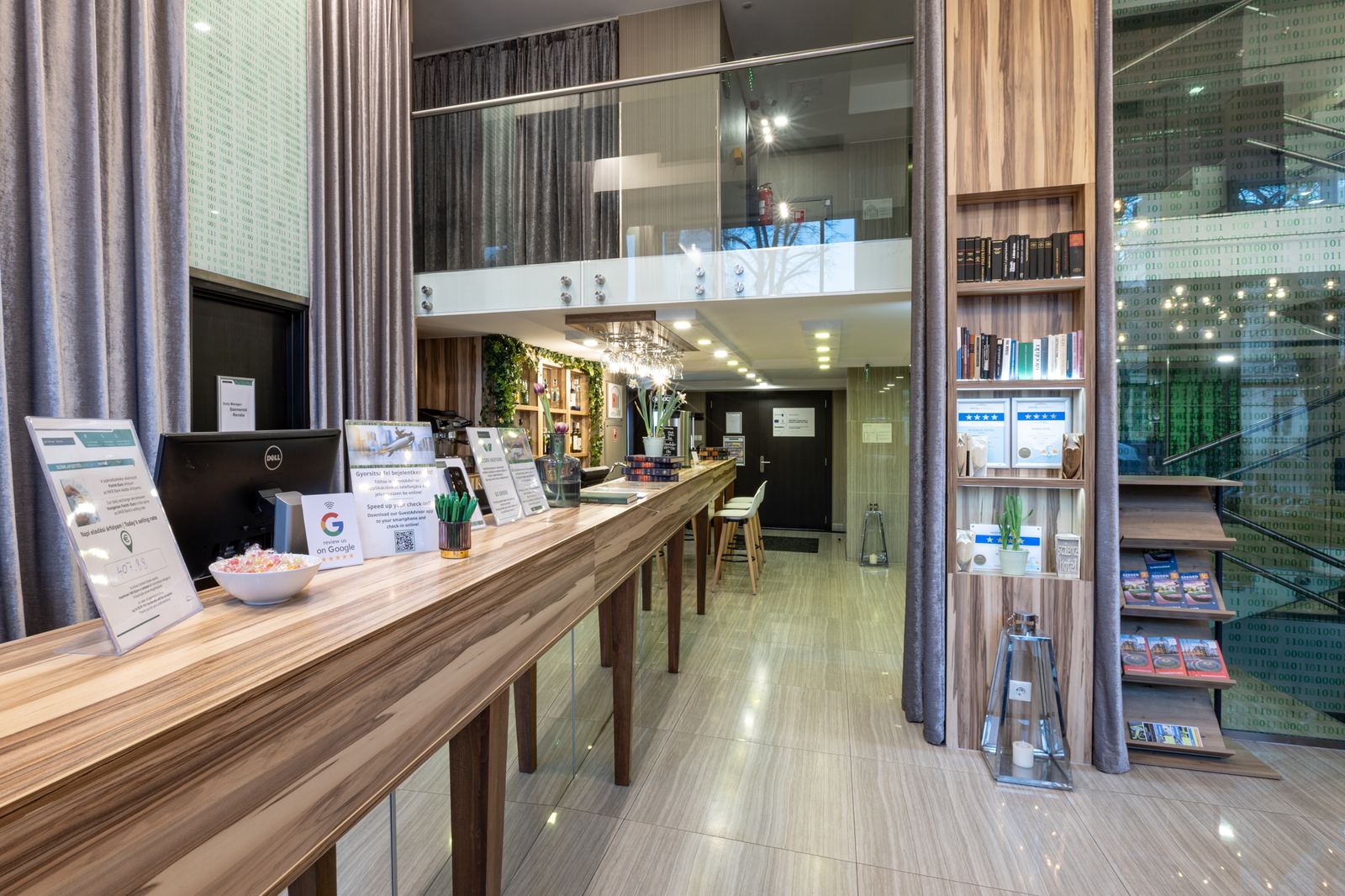 The reception with a long wooden counter, the gallery in the background